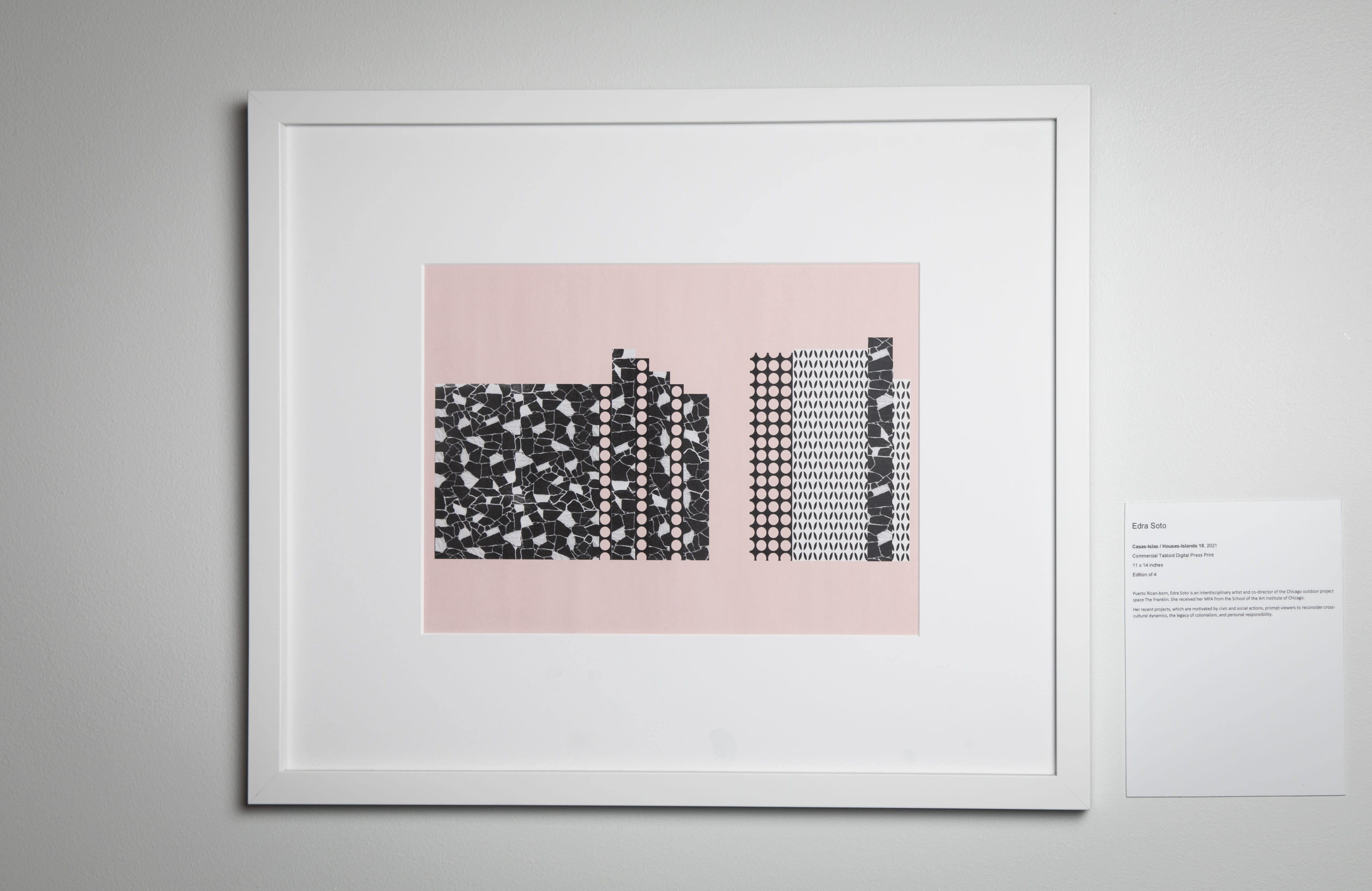 Black and white rectangular shapes are positioned vertically against a light pink background