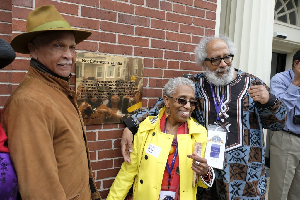 From left: Takeover participants Wayne Watson, Kimya Moyo, and John Bracey in front of the new plaque commemorating the 1968 protest at the Bursar’s Office.