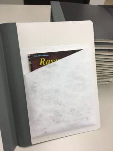 Example of pocket holding stapled-spine book