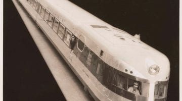 photo of black & white photo of the B&O railroad's streamlined train Comet taken from above against a black background