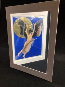 Blue, gold, and black collage with light peach paper cutout of a man. shown at an angle in a mat board frame.