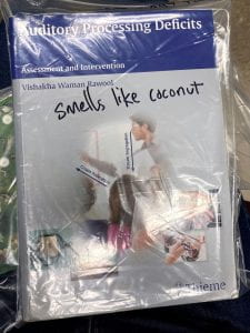 Book in a plastic bag with "smells like coconut" written on it