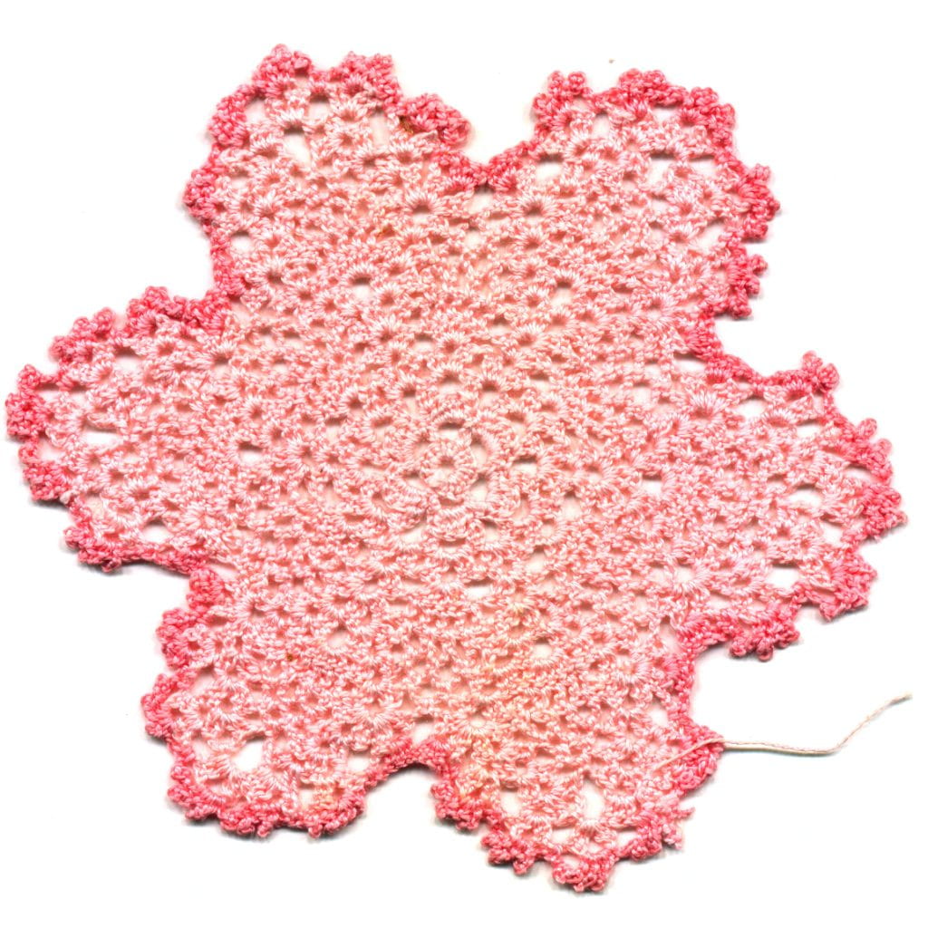 crocheted flower done in pink yarn