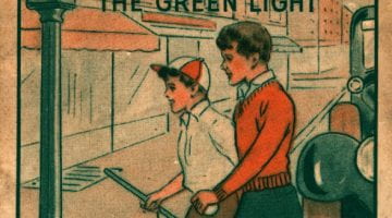 Pamphlet cover with text "play safe with the games we love" and "cross only with the green light." illustration of two children and dog crossing the street.