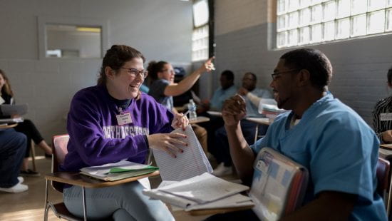 An Evanston undergraduate student laughs with an NPEP student.