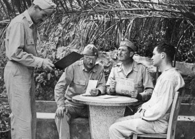 Three doctors in uniform and a patient around a concrete table in Ain-el-Turck