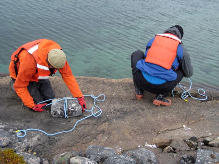 Greenland is windy. Here we're making anchors to keep the raft in place during the coring process.